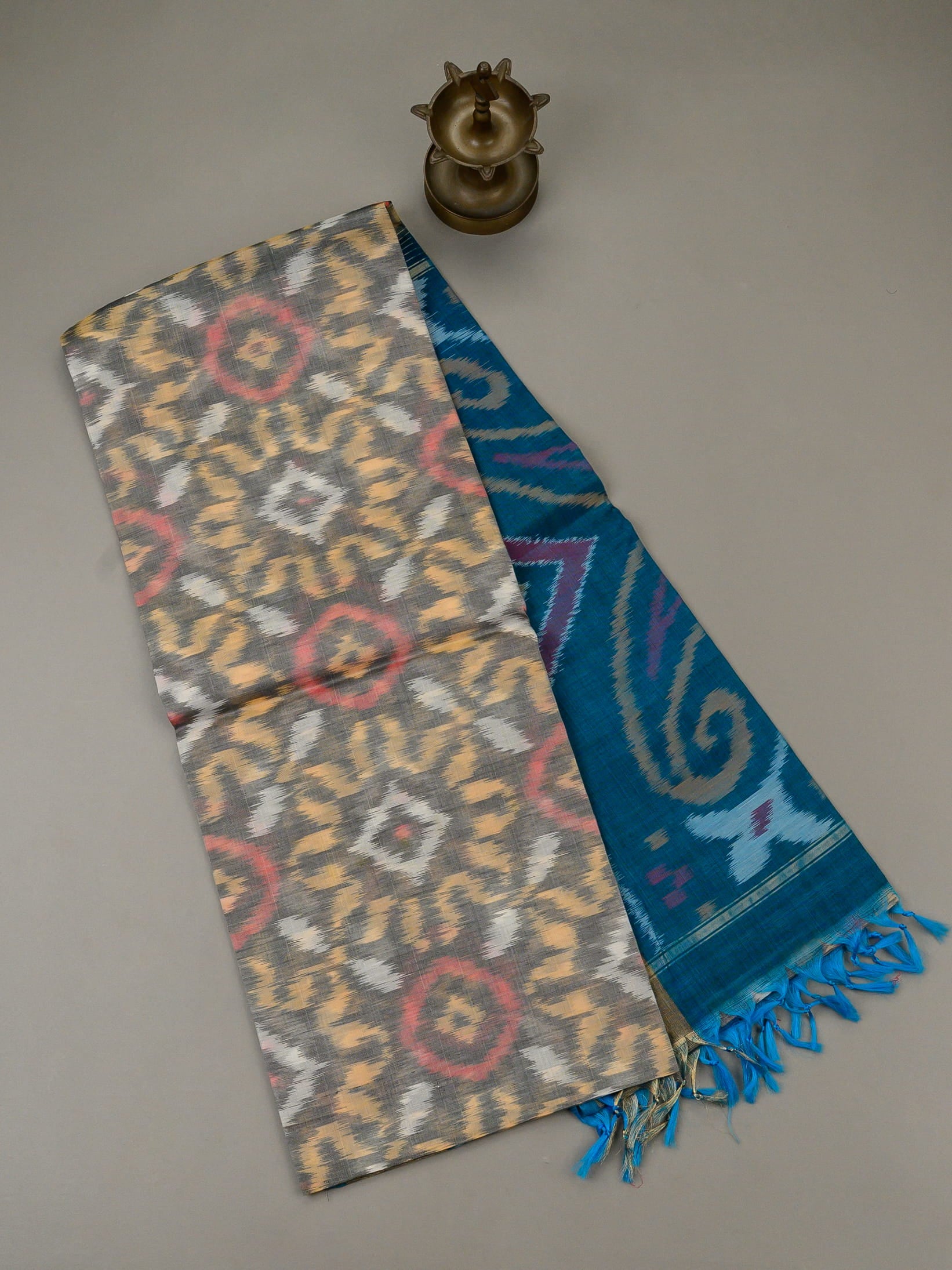 Handloom Pochampally silk cotton saree in grey and blue with circular Ikat patterns