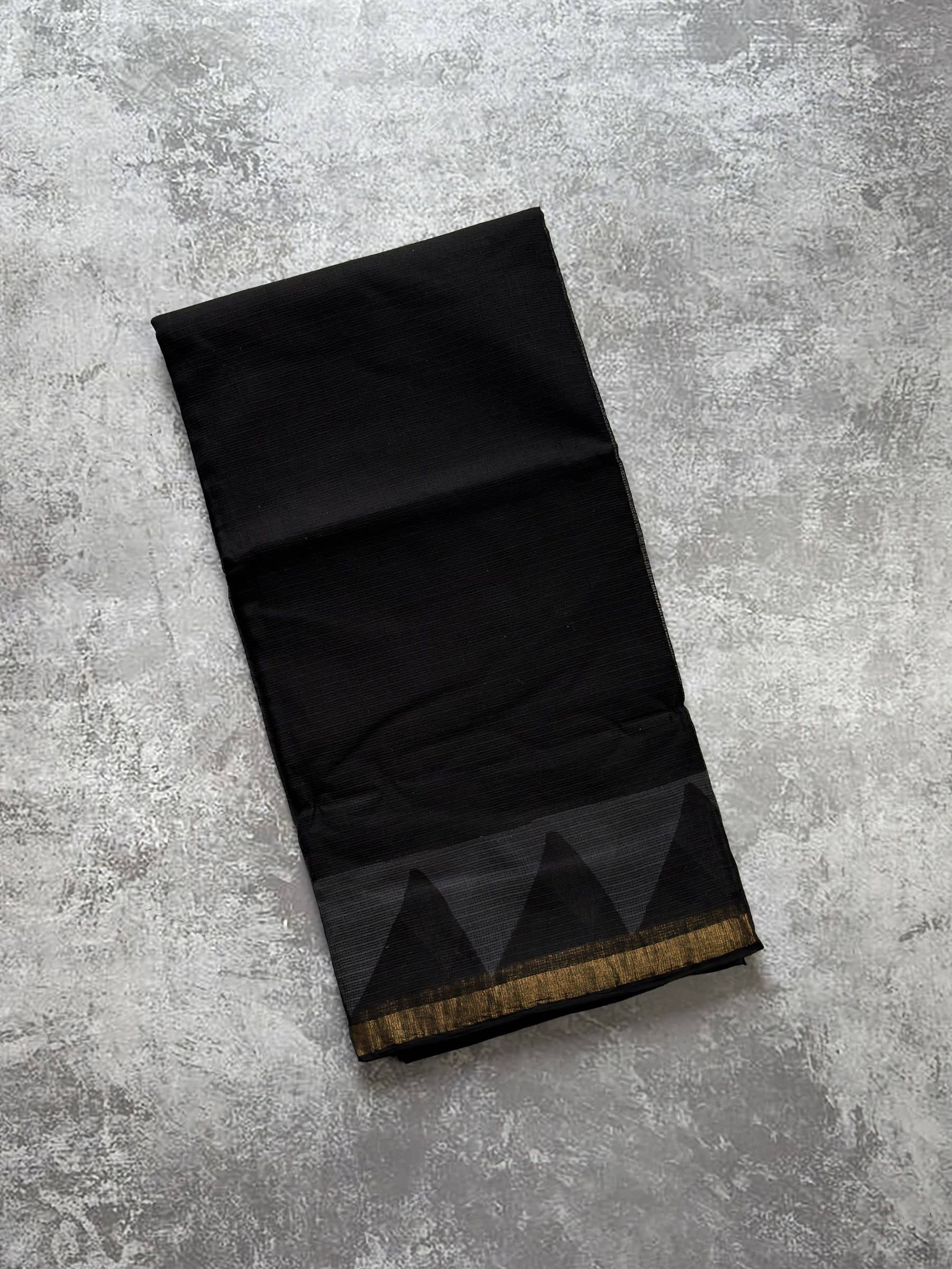 Black hand block printed Kota Doria saree with grey border and rust paisley pallu
