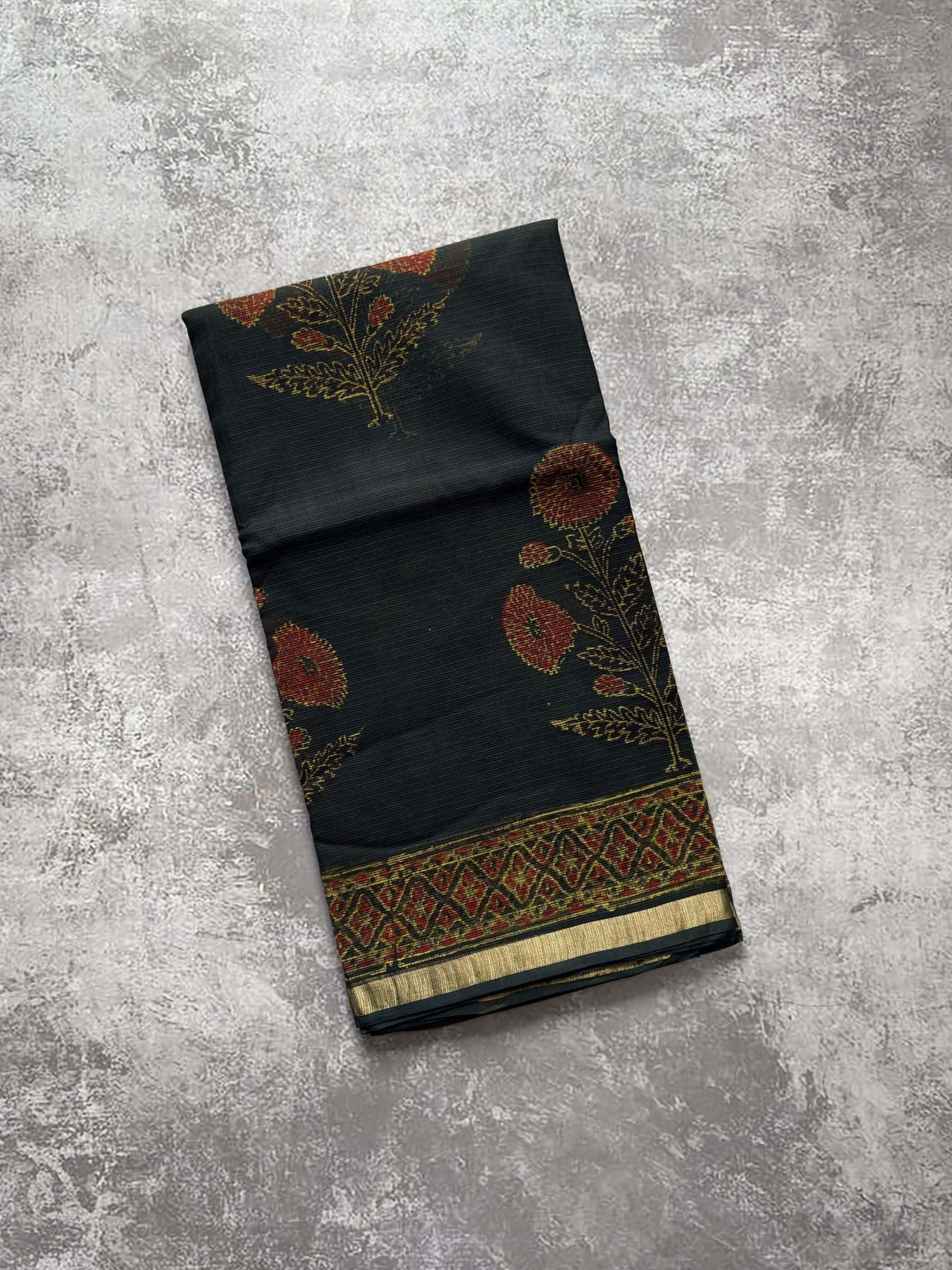 Deep green hand block printed Kota Doria saree with rust floral motifs and detailed pallu