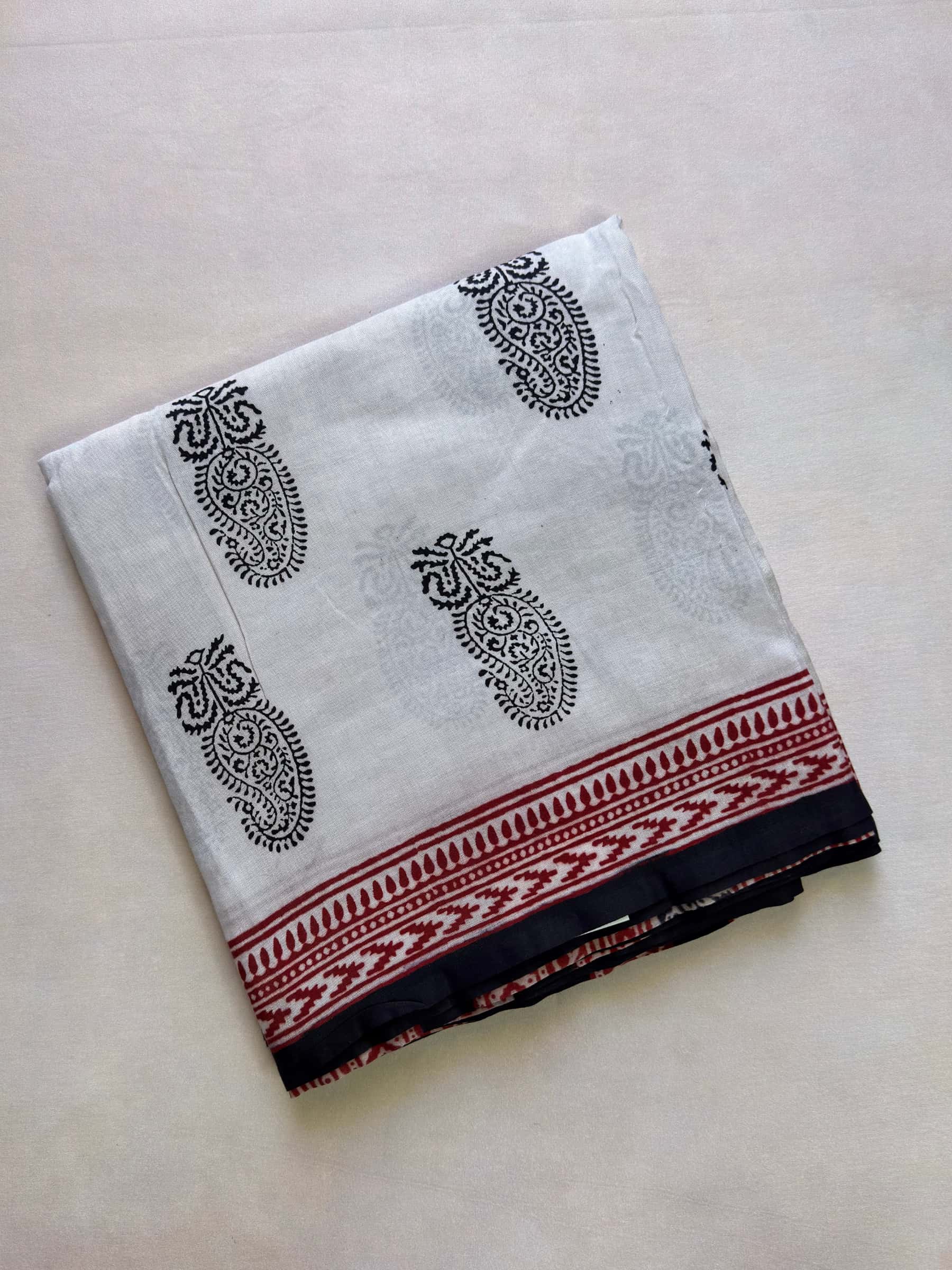 Hand block printed dabu banana silk cotton saree with paisley motifs