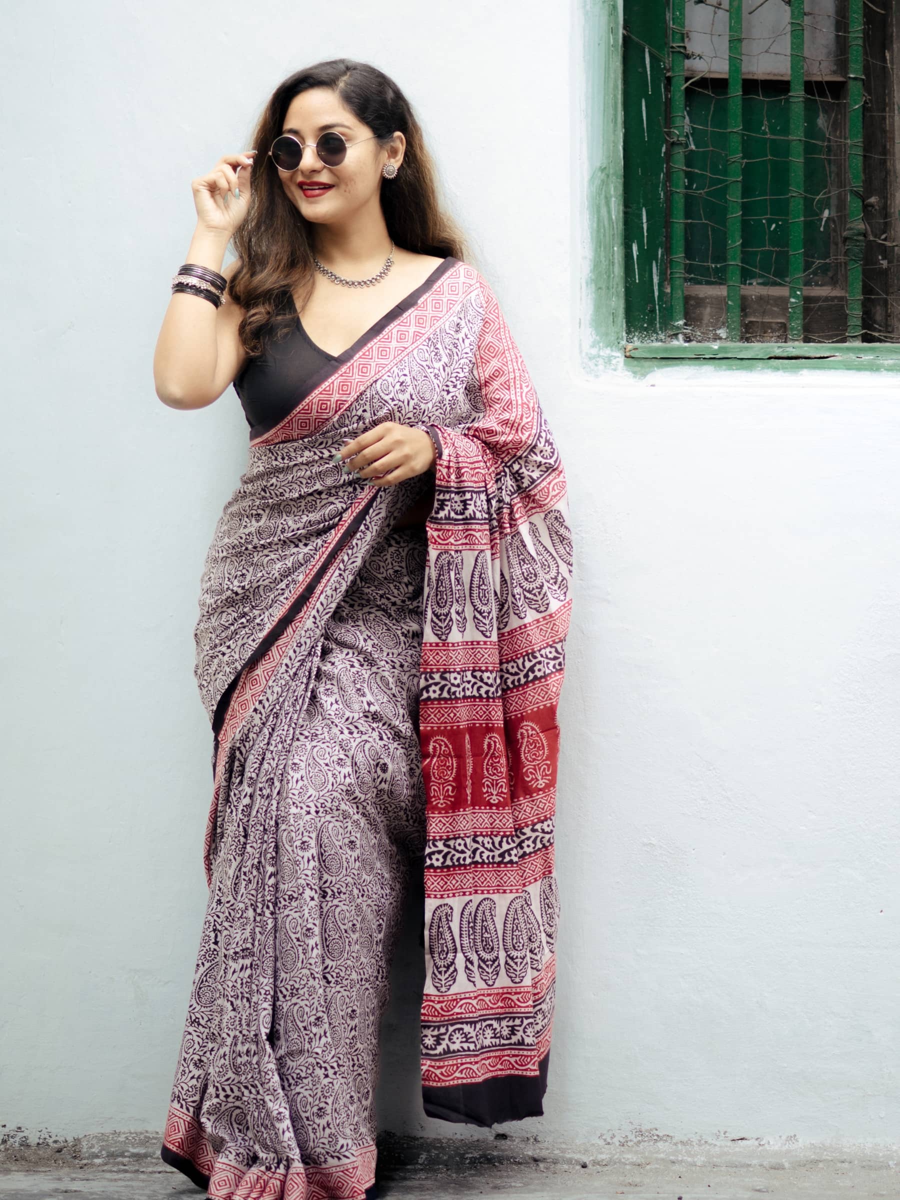 Black and white bagh printed saree with contrast red border and pallu