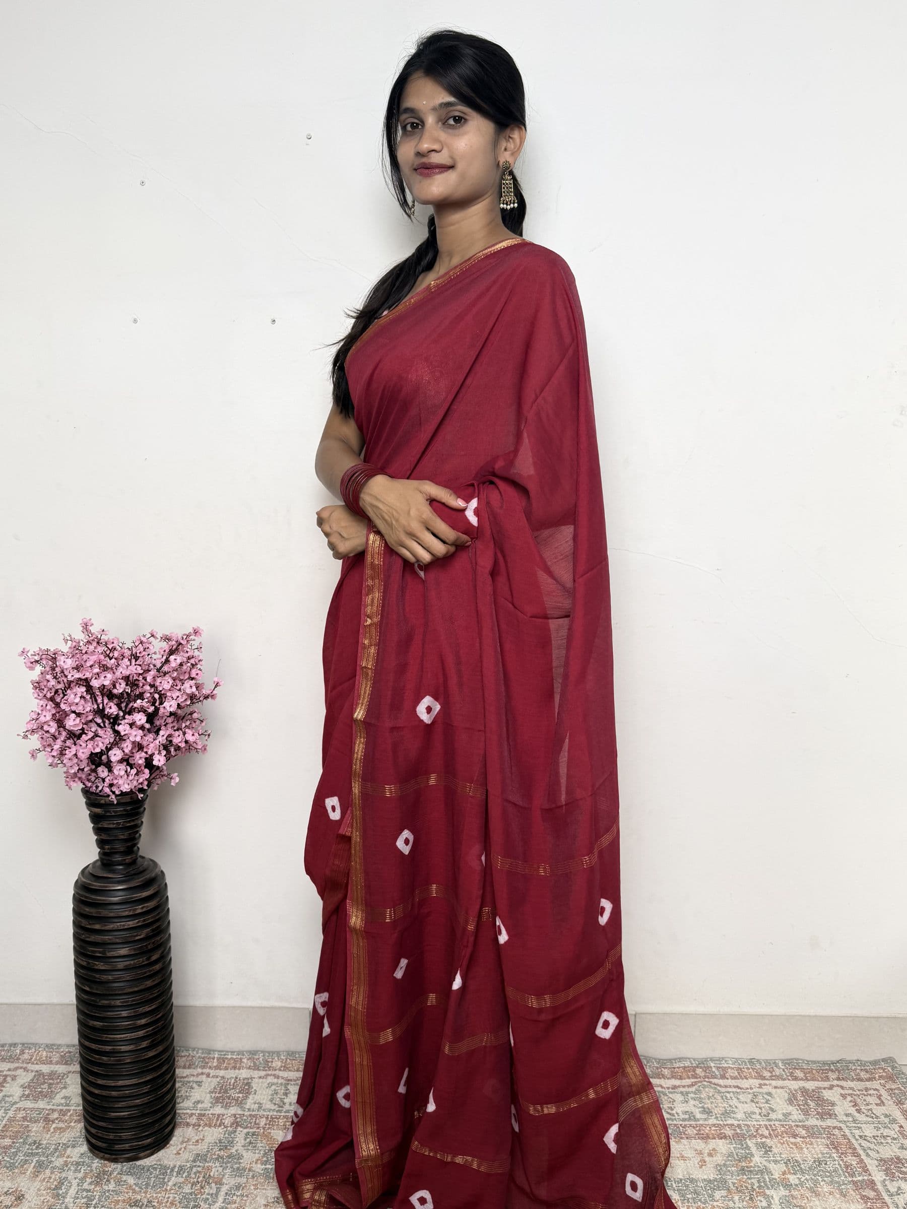 Bandhej Maheshwari cotton silk saree in deep rose red with white tie-dye motifs and gold zari border