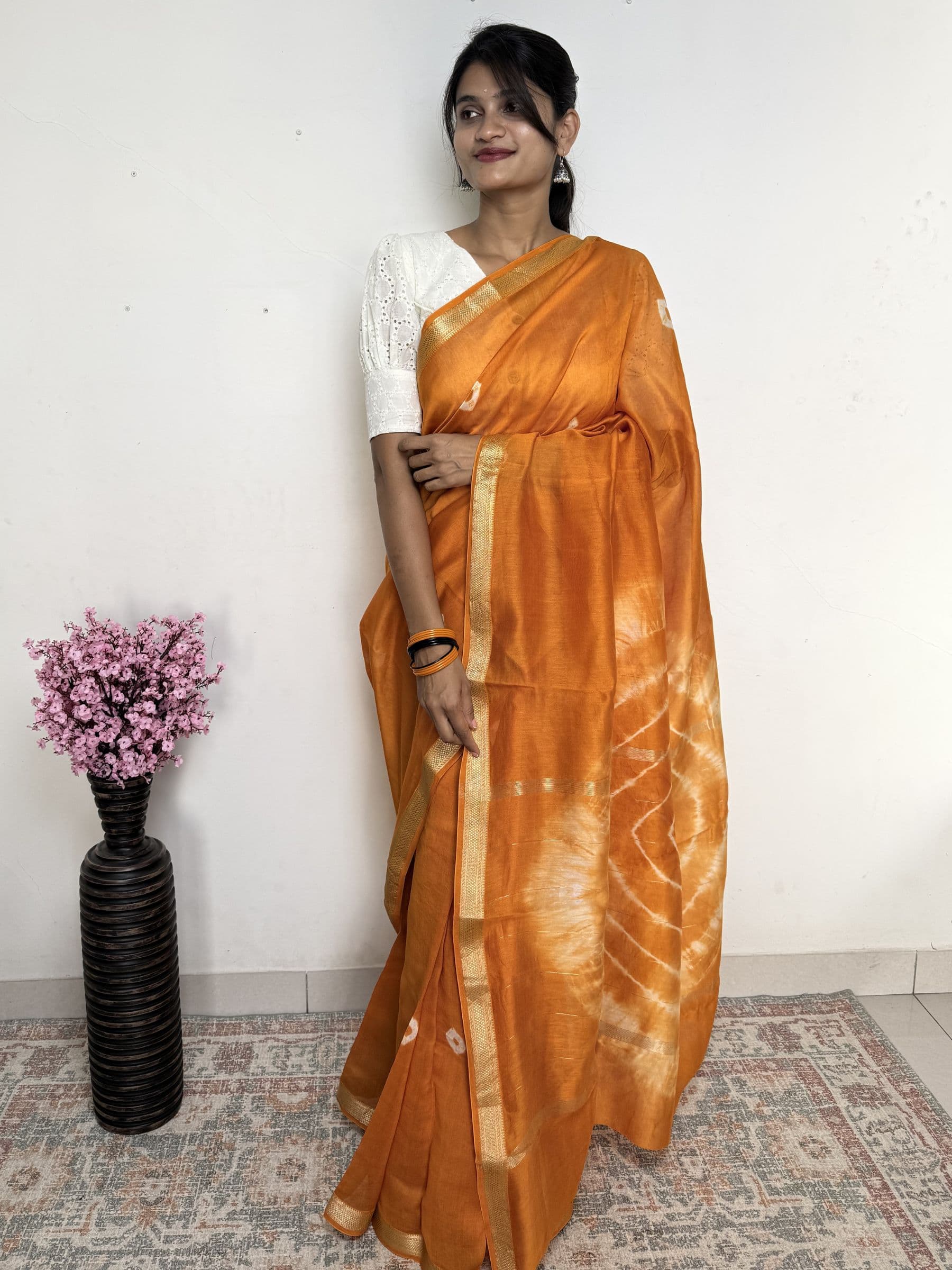 Bandhej Maheshwari cotton silk saree in mustard orange with handcrafted tie-dye motifs and gold zari border
