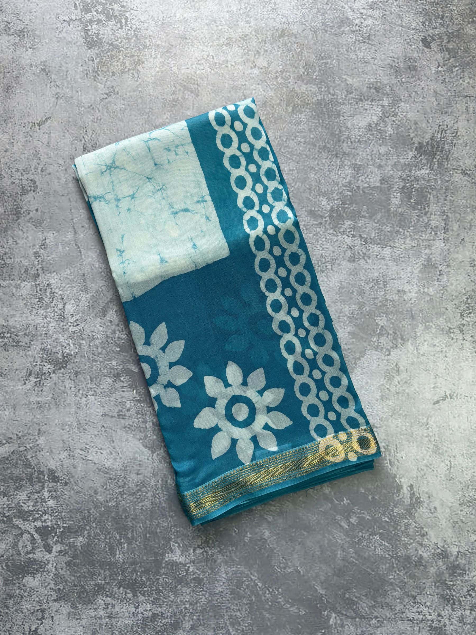Hand block printed teal Maheshwari silk cotton saree with floral motifs