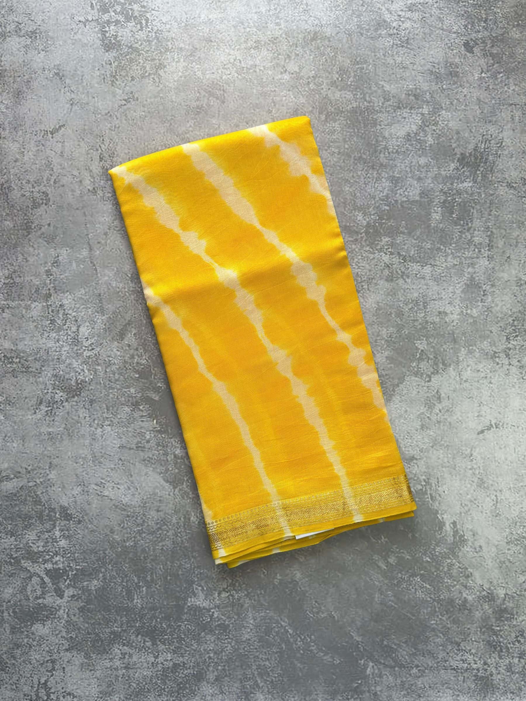 Yellow hand block printed Maheshwari silk cotton saree with diagonal patterns