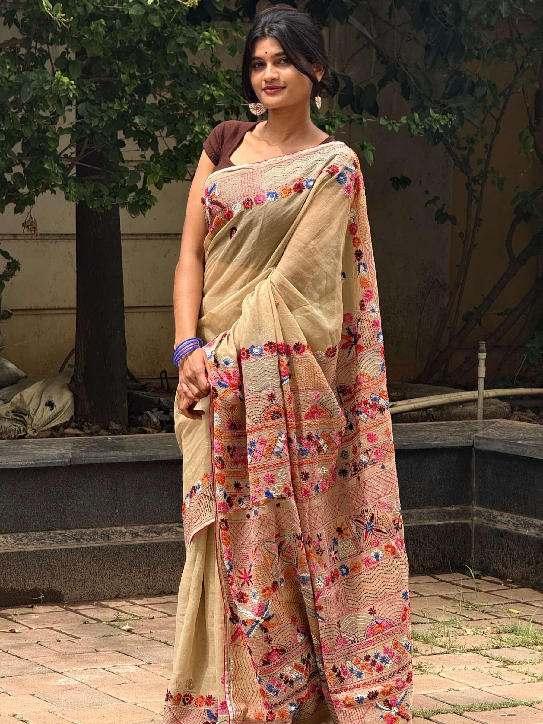 Beige Dhonekhali Tant saree with colorful hand Kantha and Gujarati stitch work