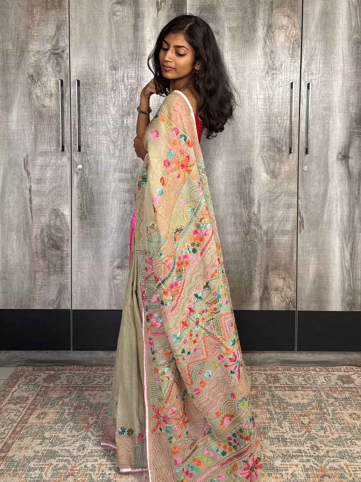 Beige Dhonekhali Tant saree with colorful floral hand embroidery
