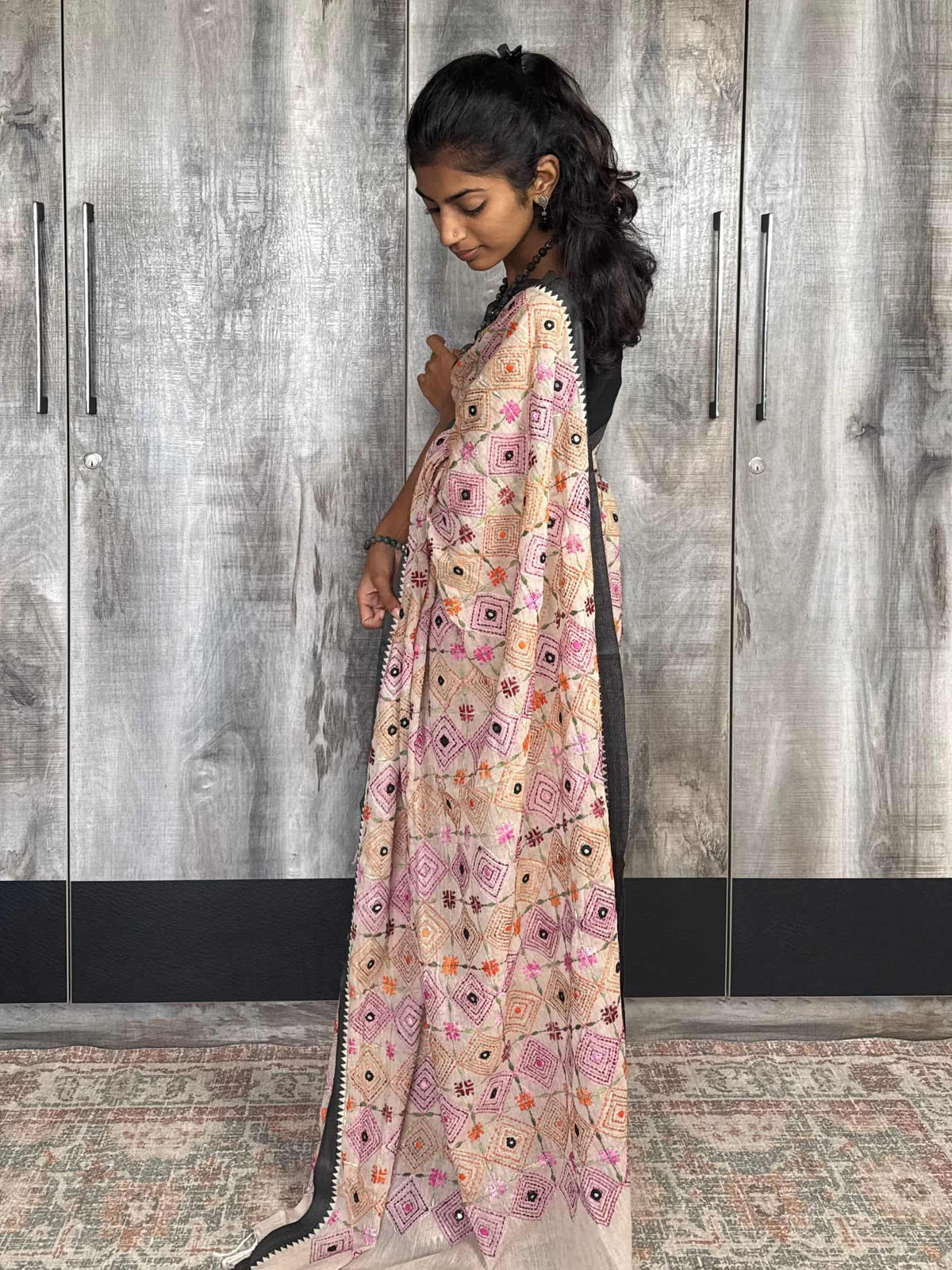 Handloom beige cotton saree with pink orange and black embroidery