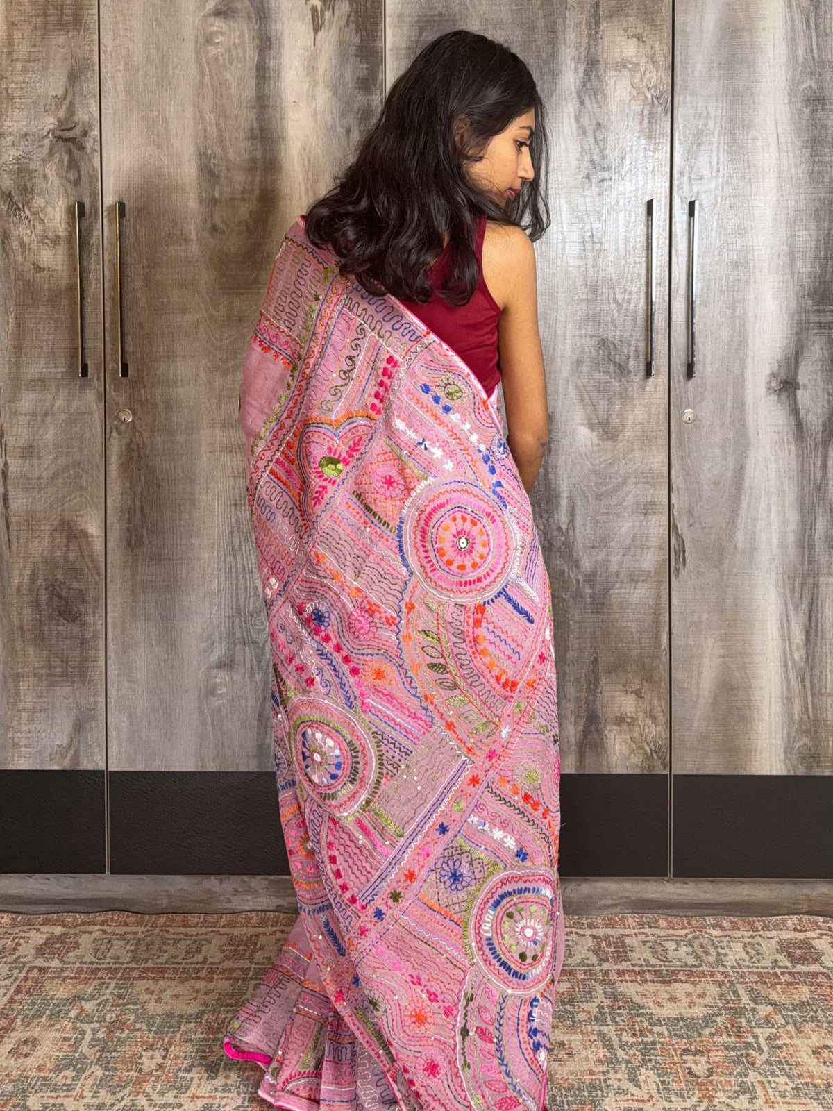 Handloom pink cotton saree with multicolor geometric hand embroidery