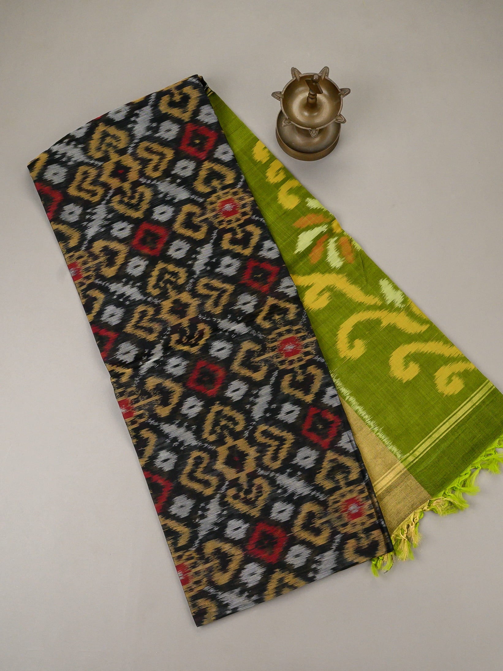 Handloom Pochampally silk cotton saree in black and green with floral Ikat weave