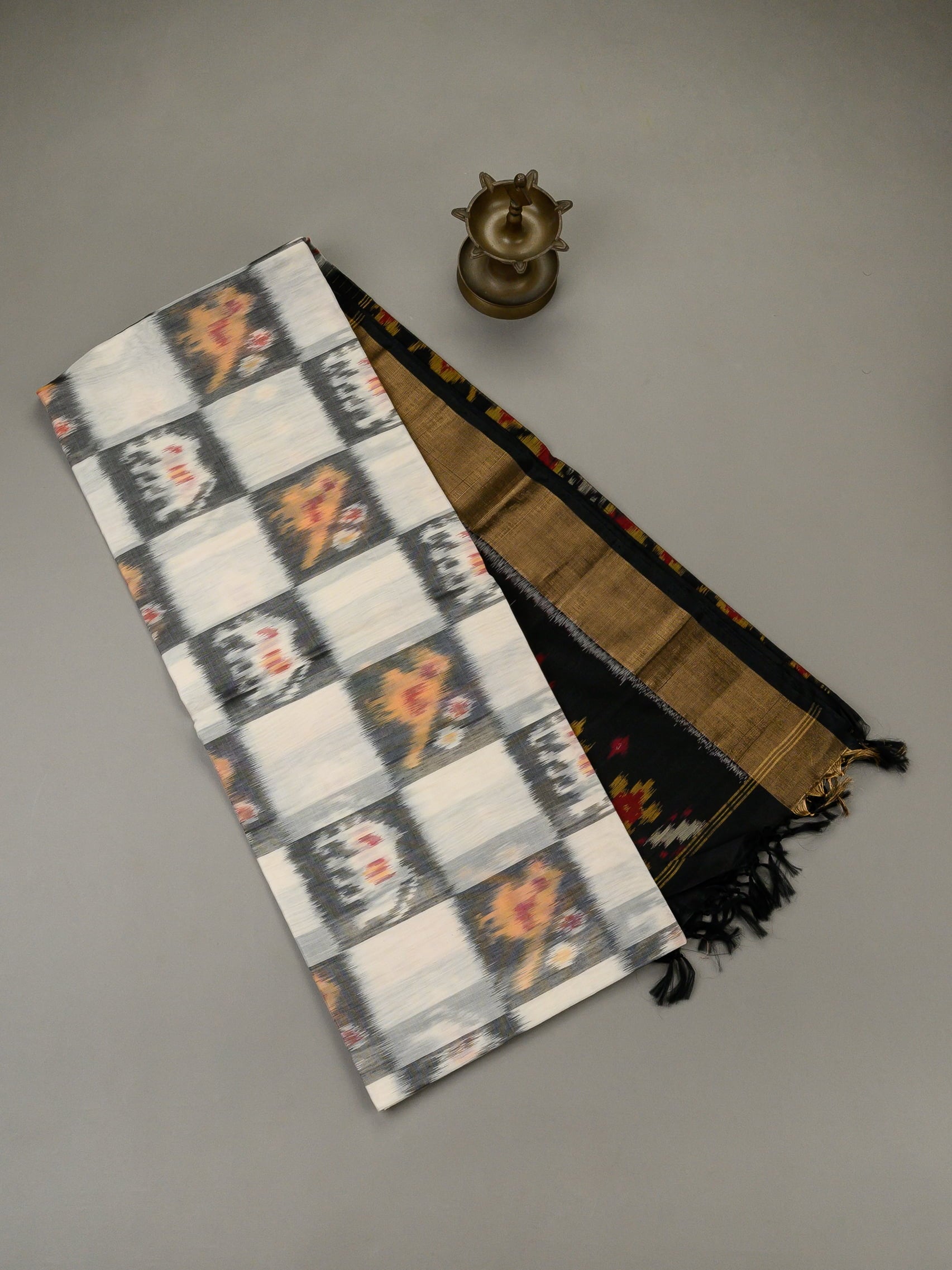 Handloom Pochampally silk cotton saree in white and black with floral Ikat motifs