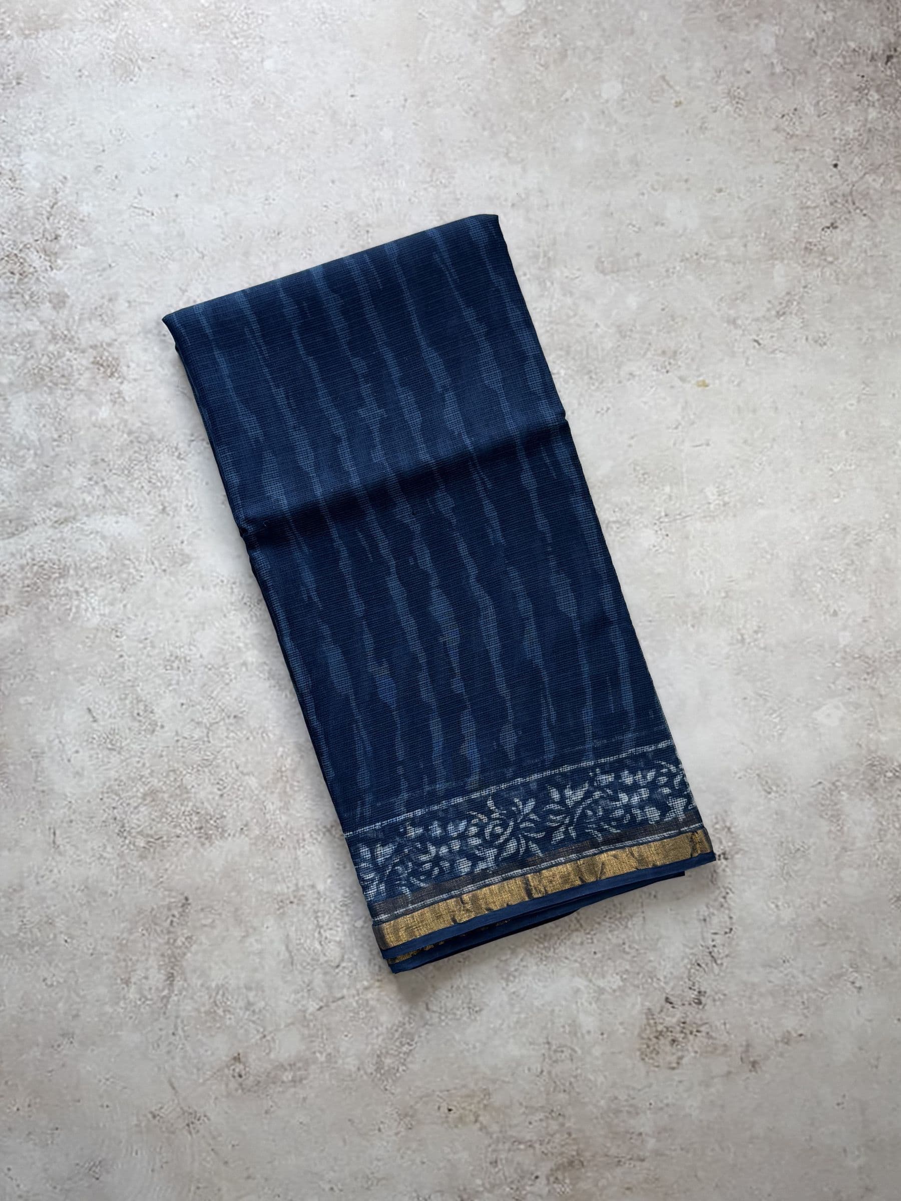 Hand block printed Bagru Kota Doria saree in indigo blue with floral border design