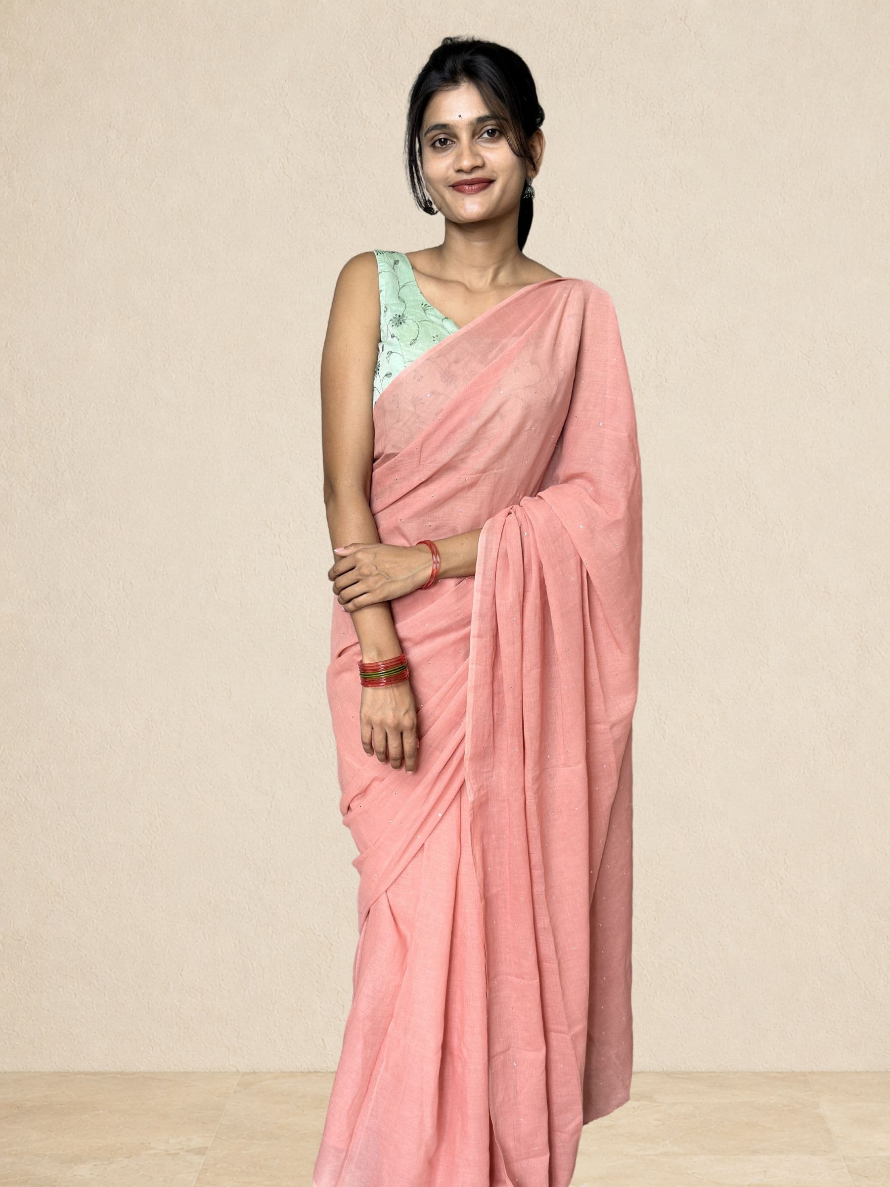 Lightweight peach mul cotton saree featuring delicate Mukaish work and crochet edging